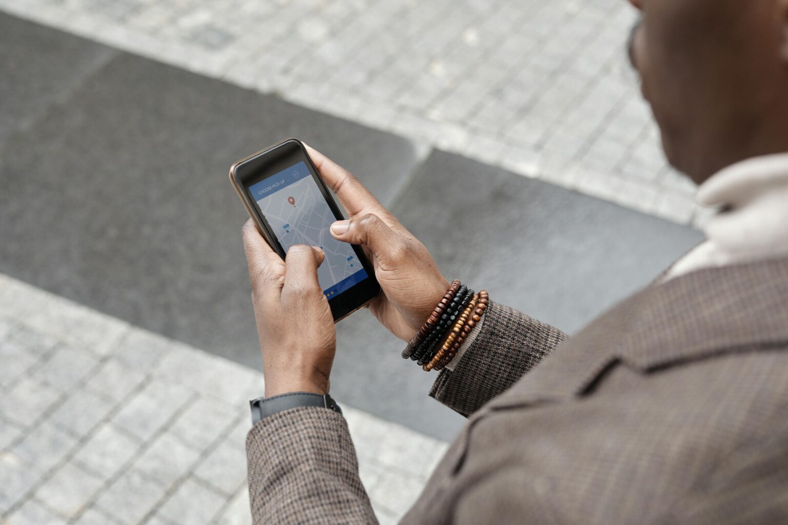 A person using a cell phone to navigate a hospital near him